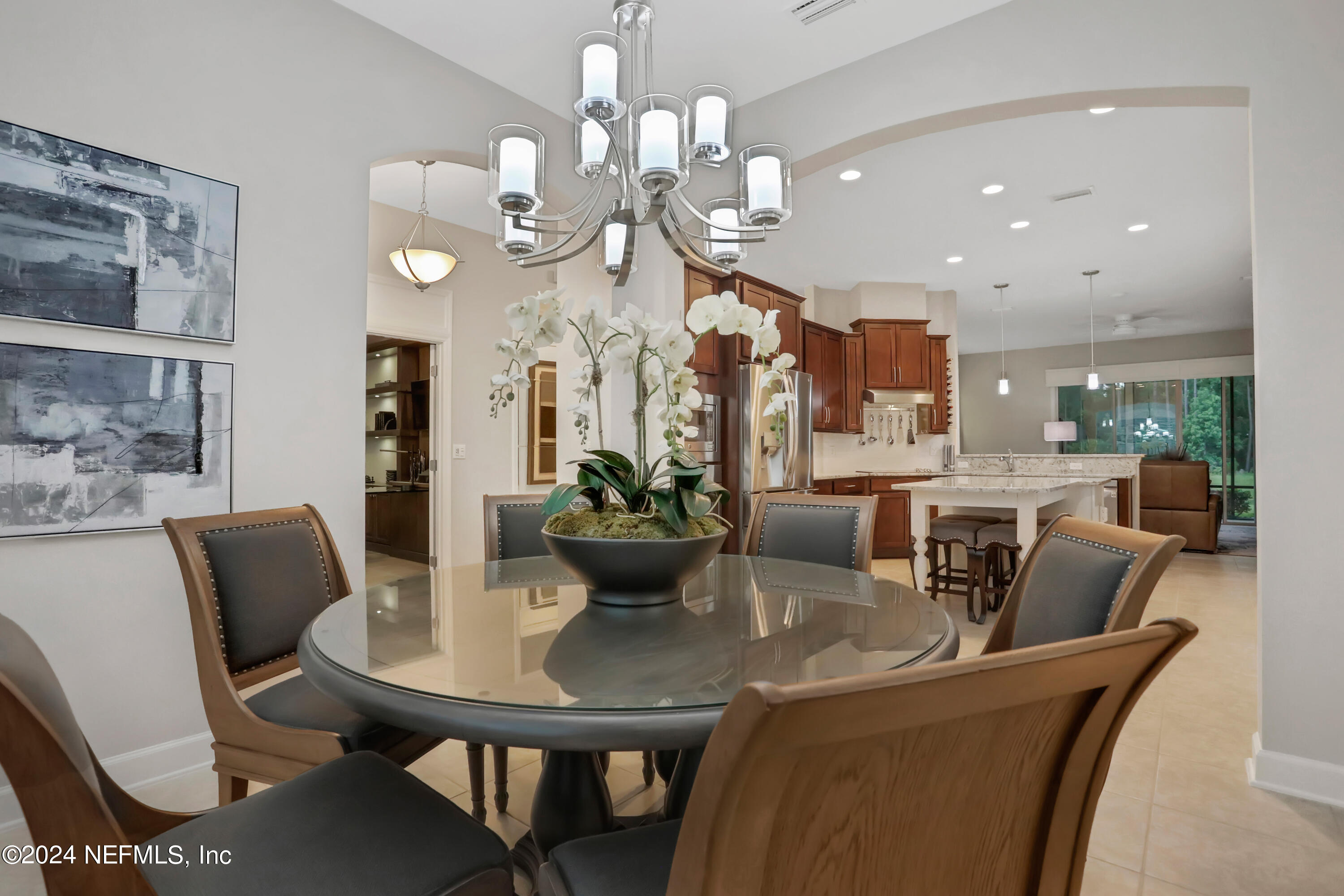 183 Flora Lake Circle St. Augustine, FL 32095 - Photo 19 of 40 a view of a dining room with furniture and a chandelier