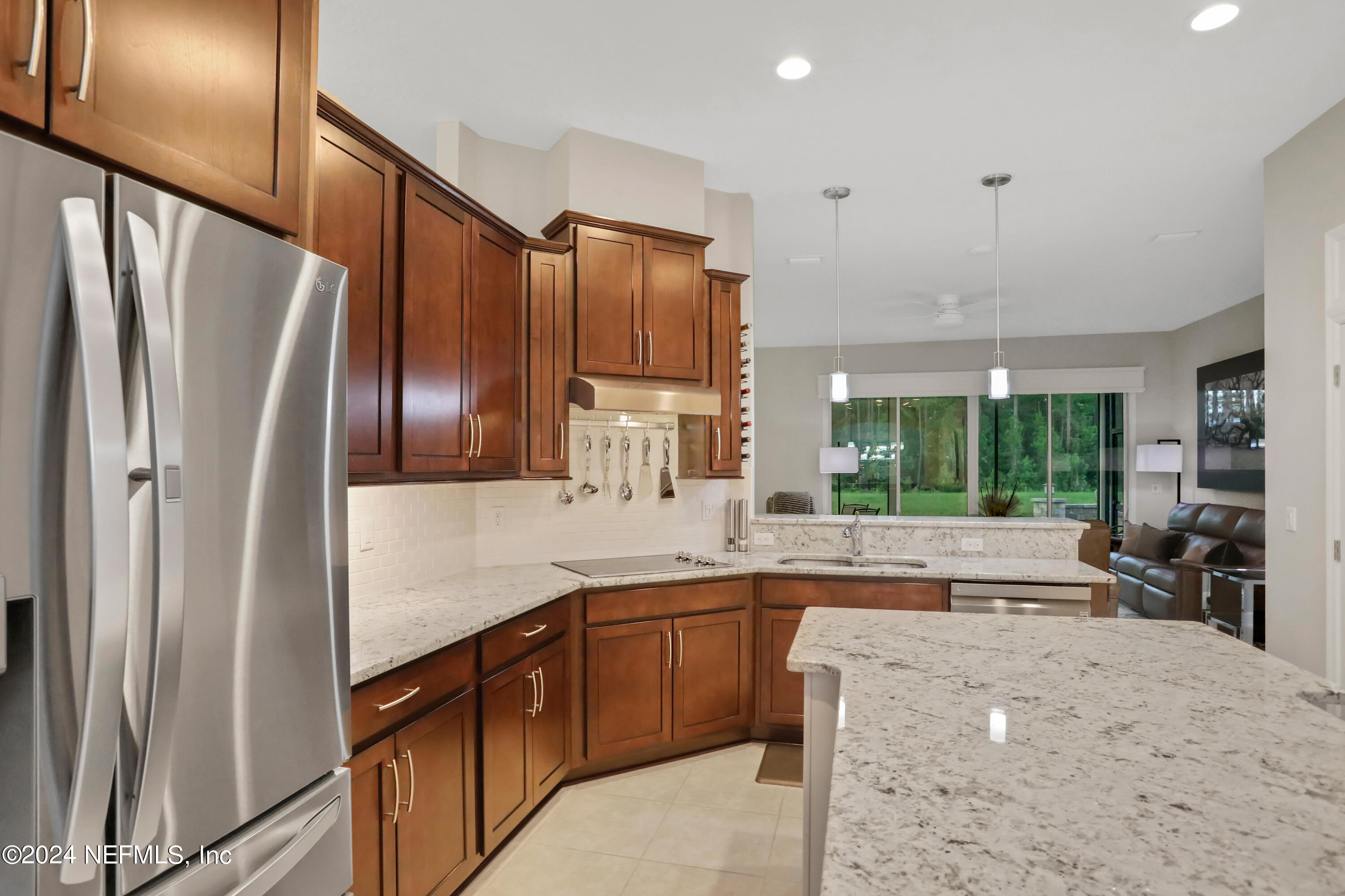 183 Flora Lake Circle St. Augustine, FL 32095 - Photo 21 of 40 a kitchen with stainless steel appliances granite countertop a refrigerator and a sink