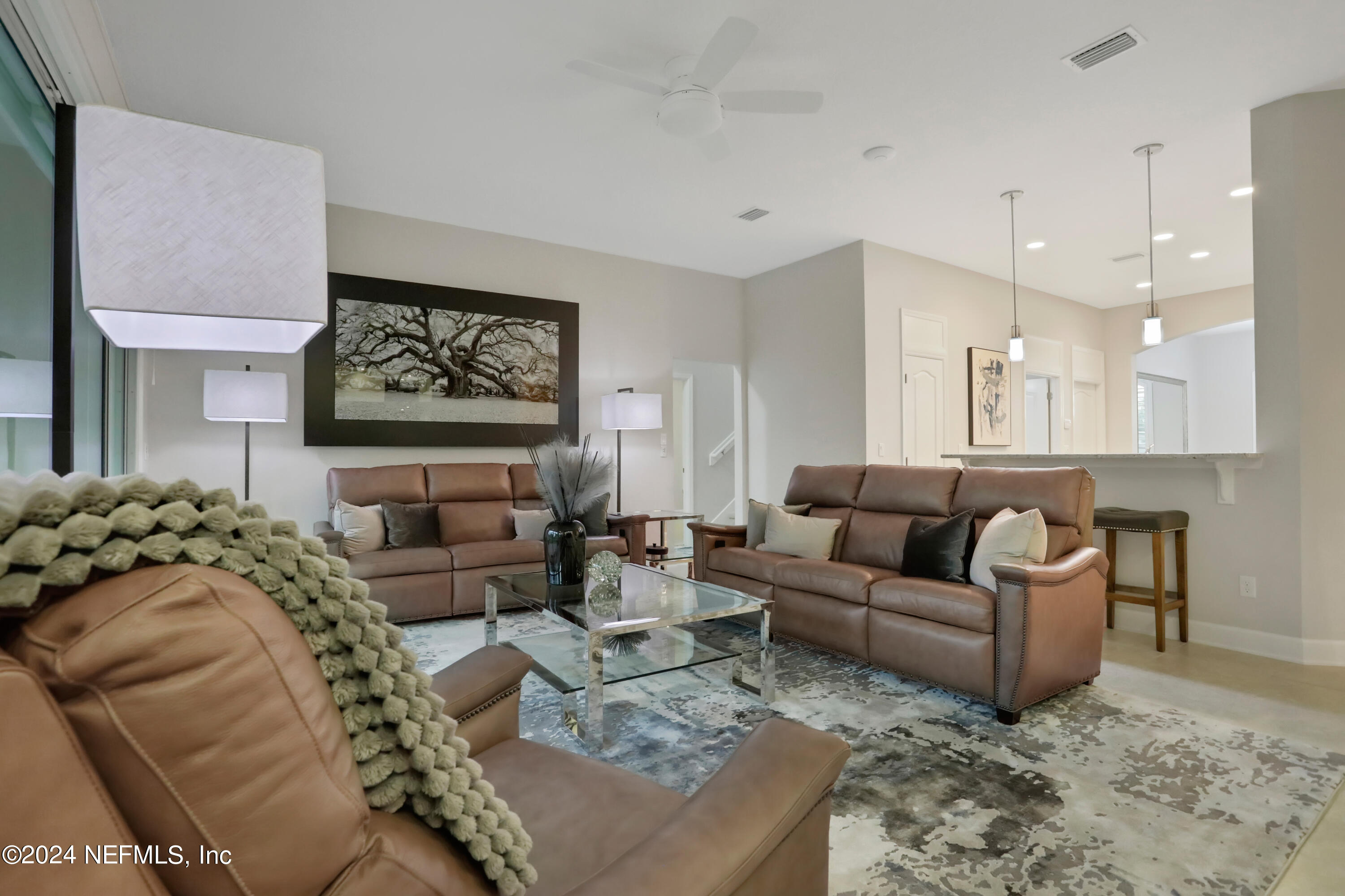 183 Flora Lake Circle St. Augustine, FL 32095 - Photo 24 of 40 a living room with furniture and a view of kitchen