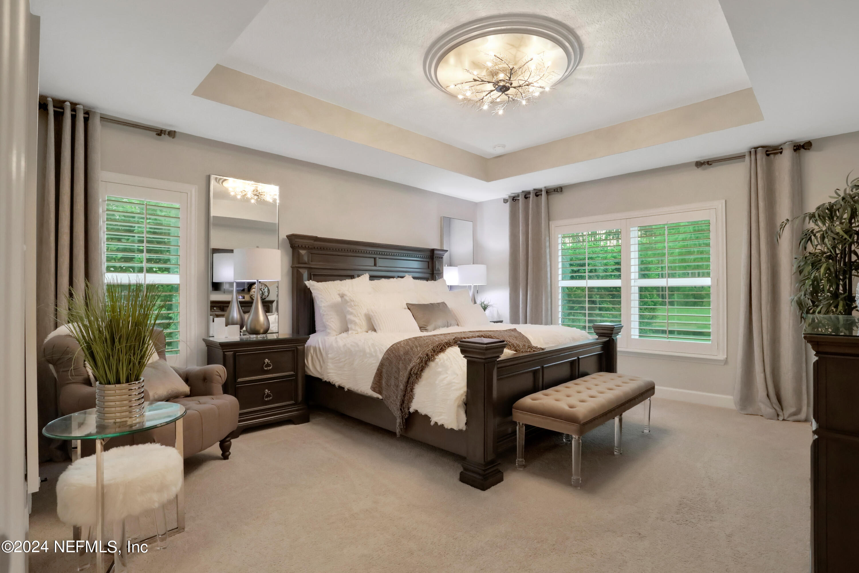 183 Flora Lake Circle St. Augustine, FL 32095 - Photo 29 of 40 a bedroom with a bed and a chandelier