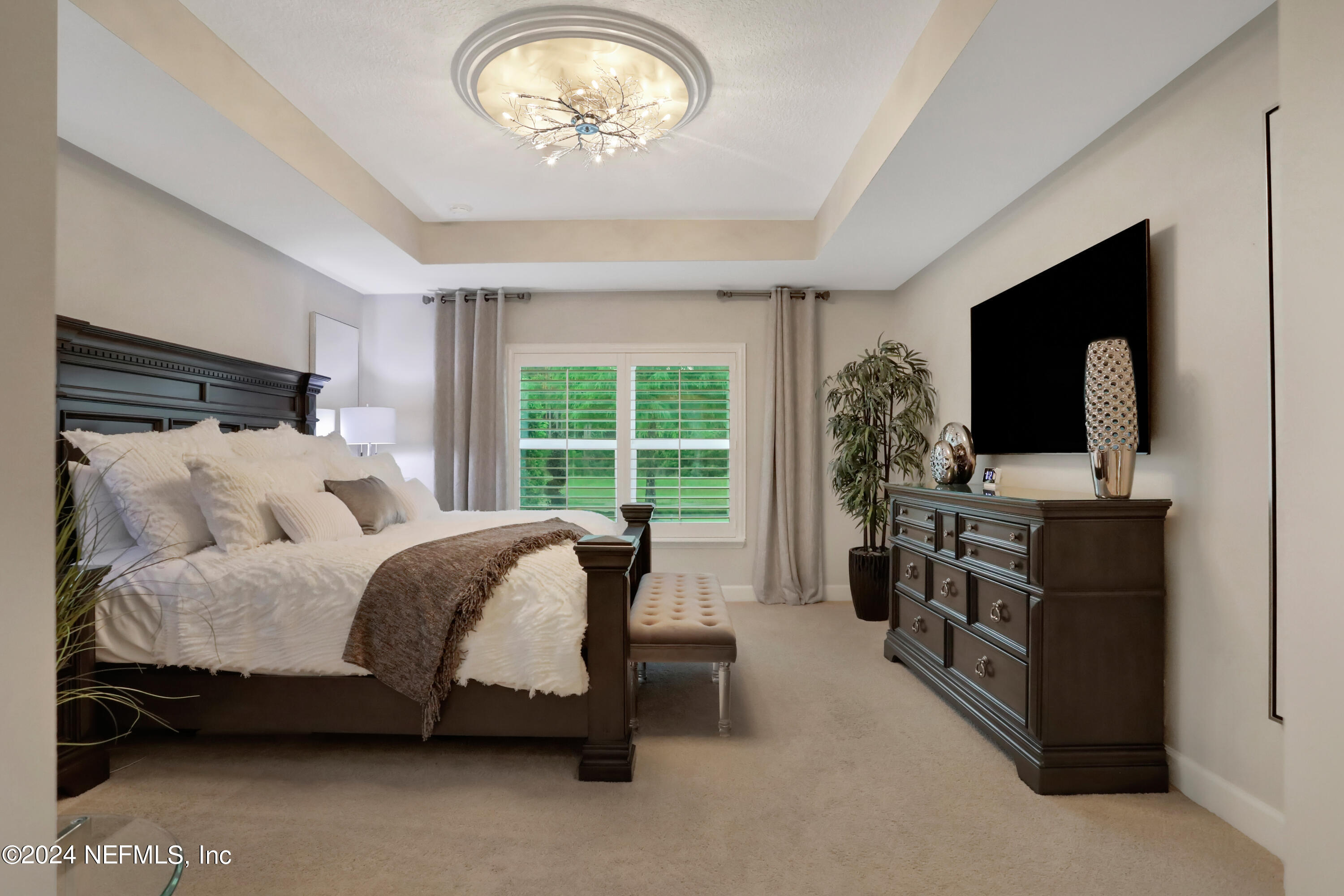 183 Flora Lake Circle St. Augustine, FL 32095 - Photo 30 of 40 a spacious bedroom with a bed and a flat tv screen on the dresser