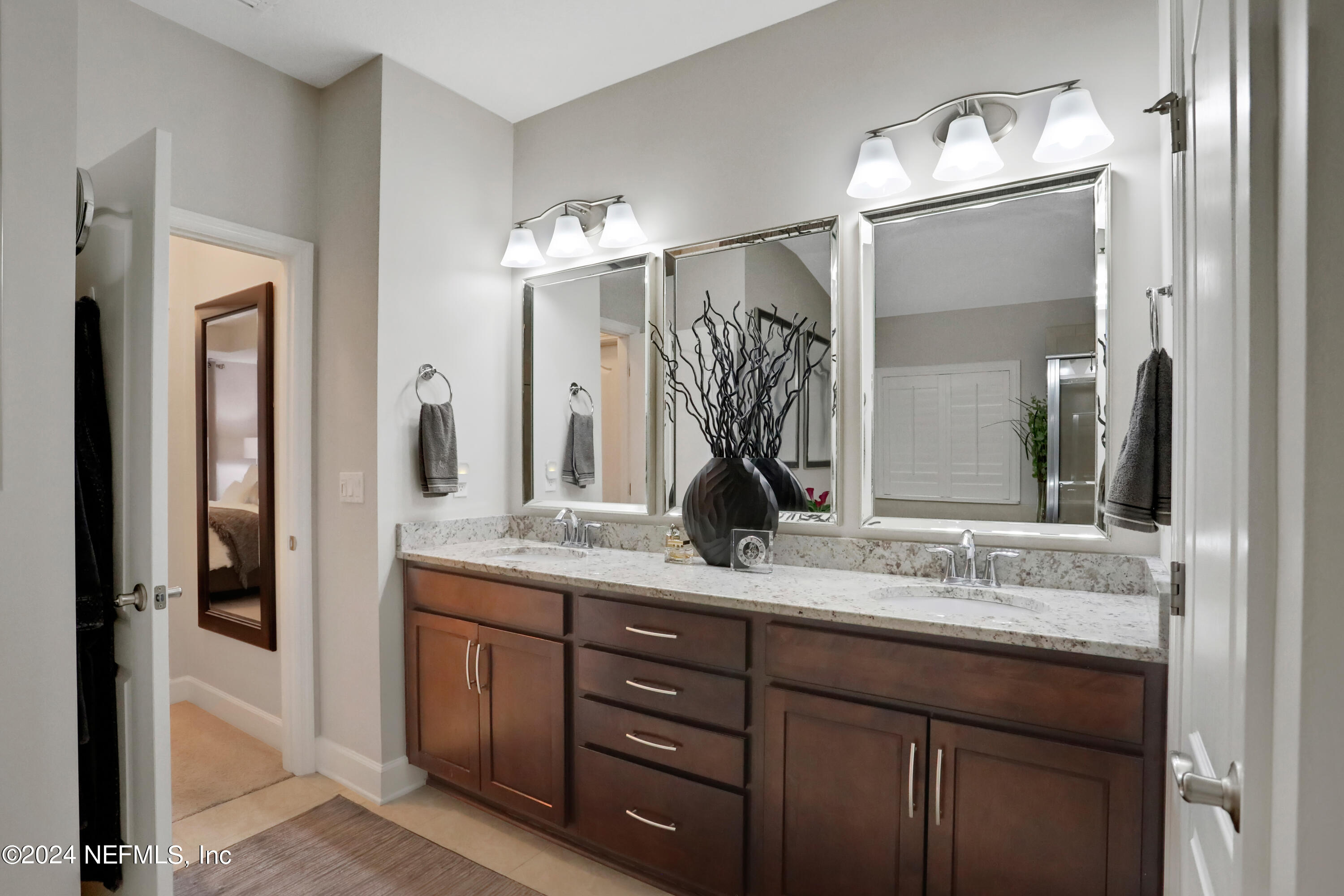 183 Flora Lake Circle St. Augustine, FL 32095 - Photo 33 of 40 a bathroom with a granite countertop sink vanity and a mirror