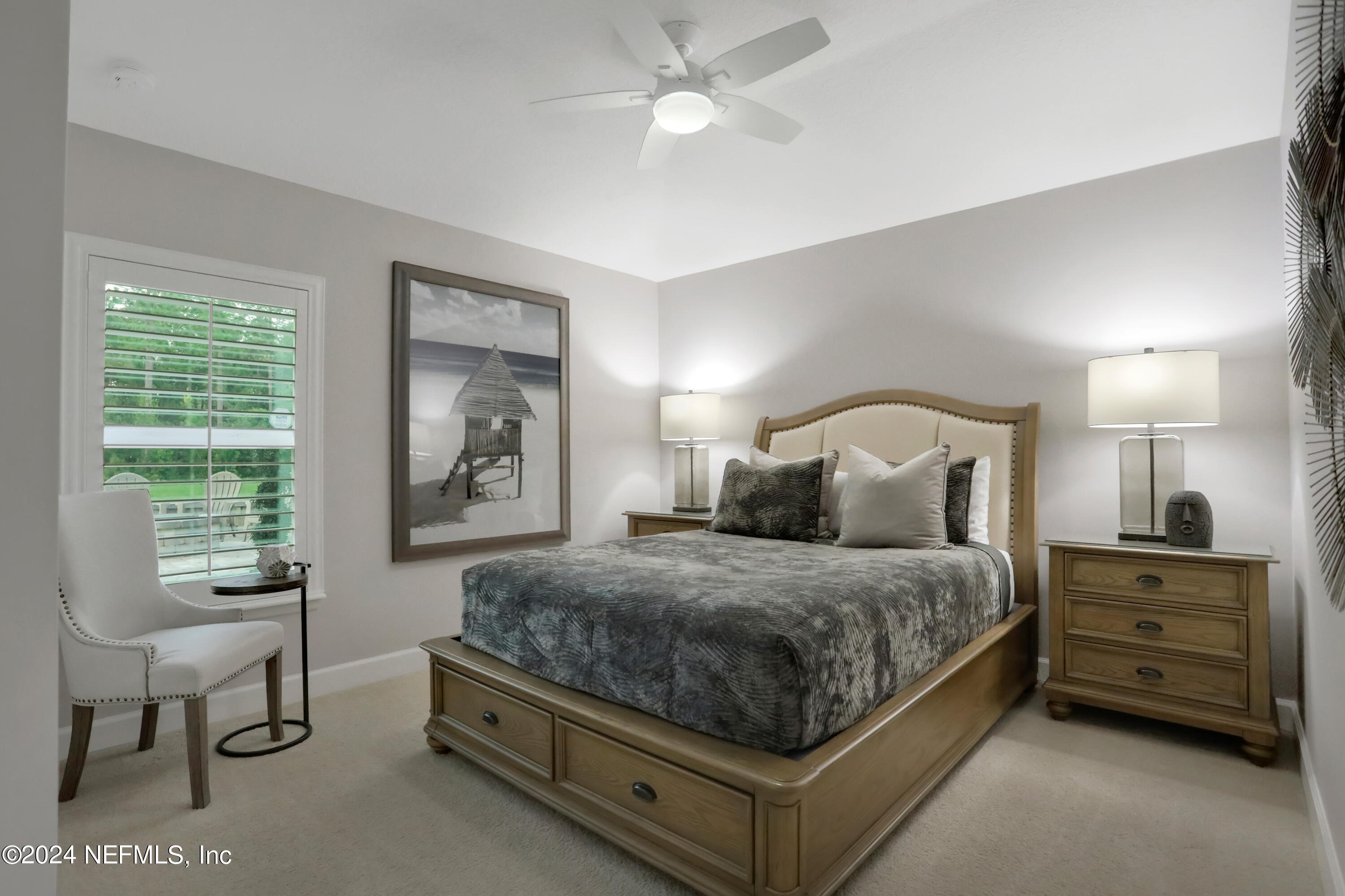 183 Flora Lake Circle St. Augustine, FL 32095 - Photo 34 of 40 a bedroom with a bed and a chandelier