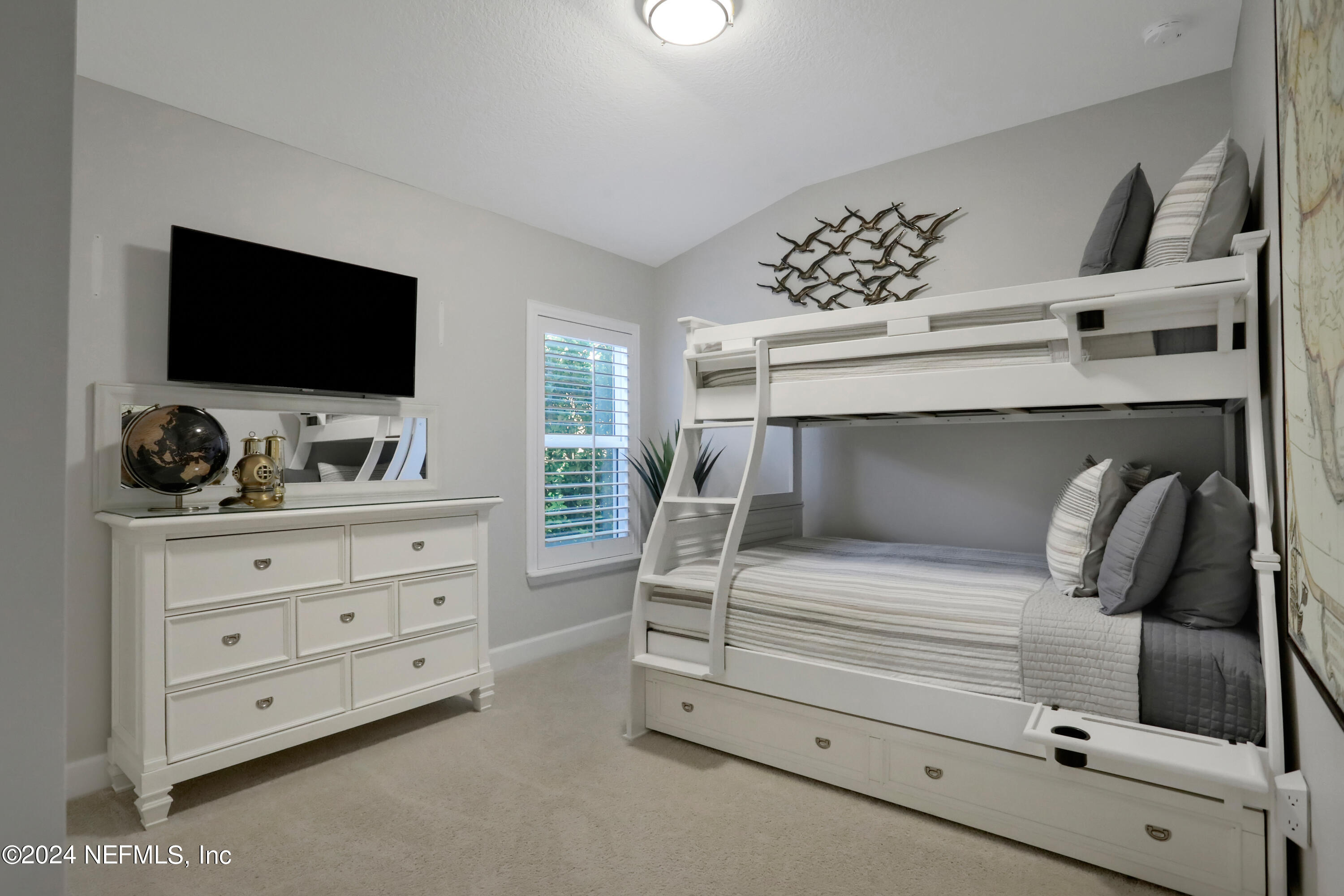 183 Flora Lake Circle St. Augustine, FL 32095 - Photo 35 of 40 a bedroom with a bed and a flat screen tv