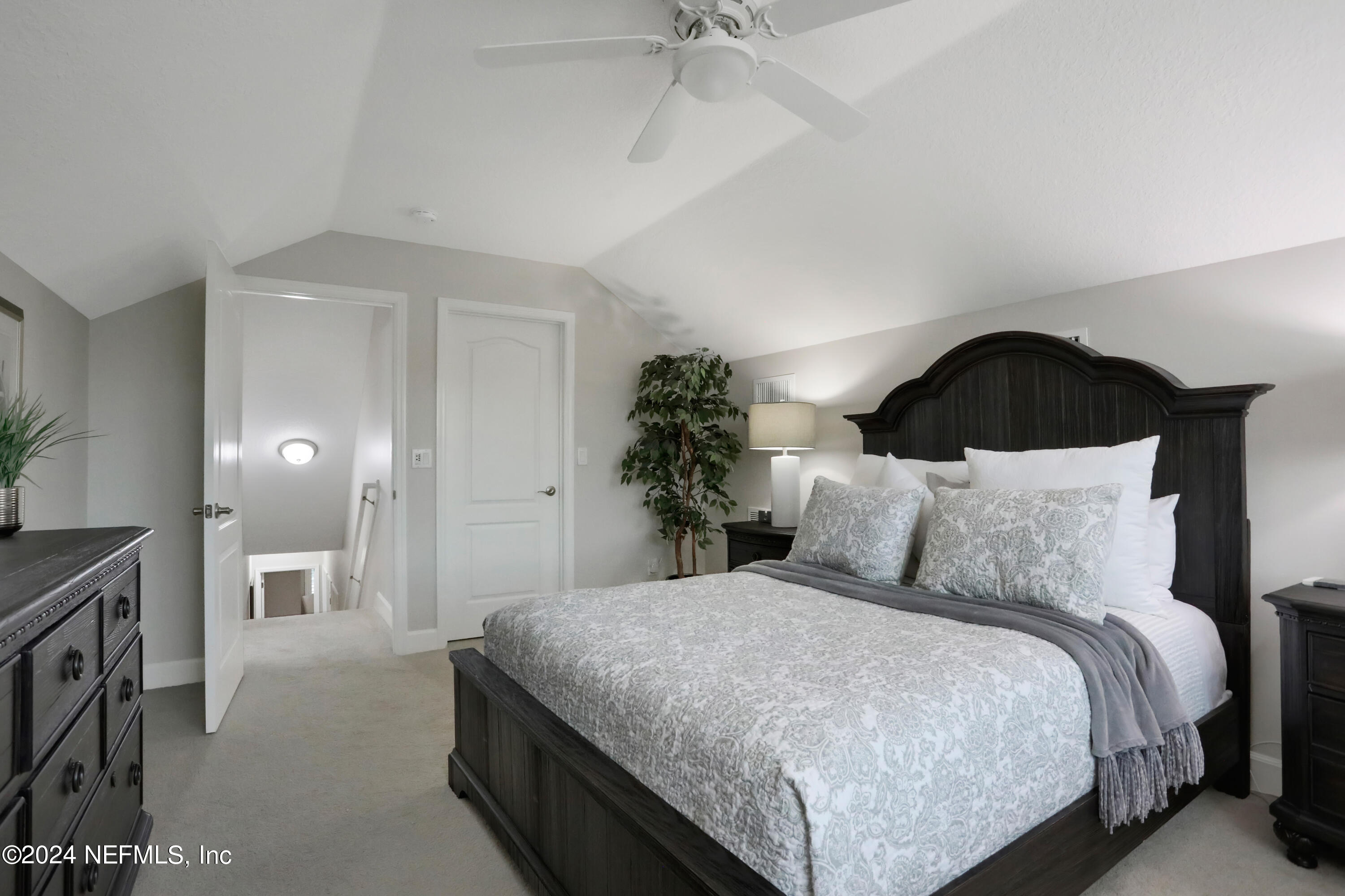 183 Flora Lake Circle St. Augustine, FL 32095 - Photo 37 of 40 a large bed sitting in a bedroom and a chandelier