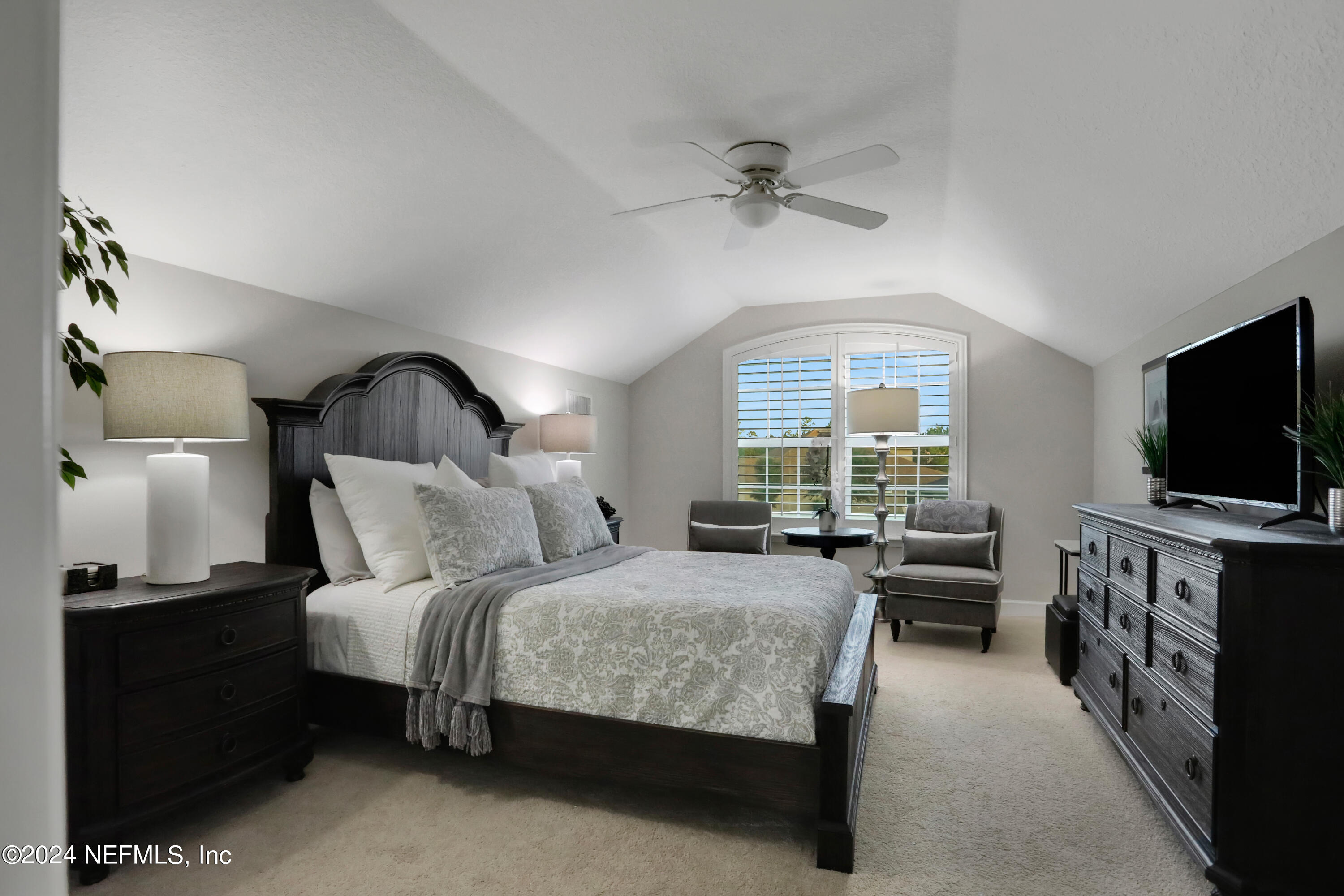 183 Flora Lake Circle St. Augustine, FL 32095 - Photo 38 of 40 a bedroom with a bed and a flat screen tv