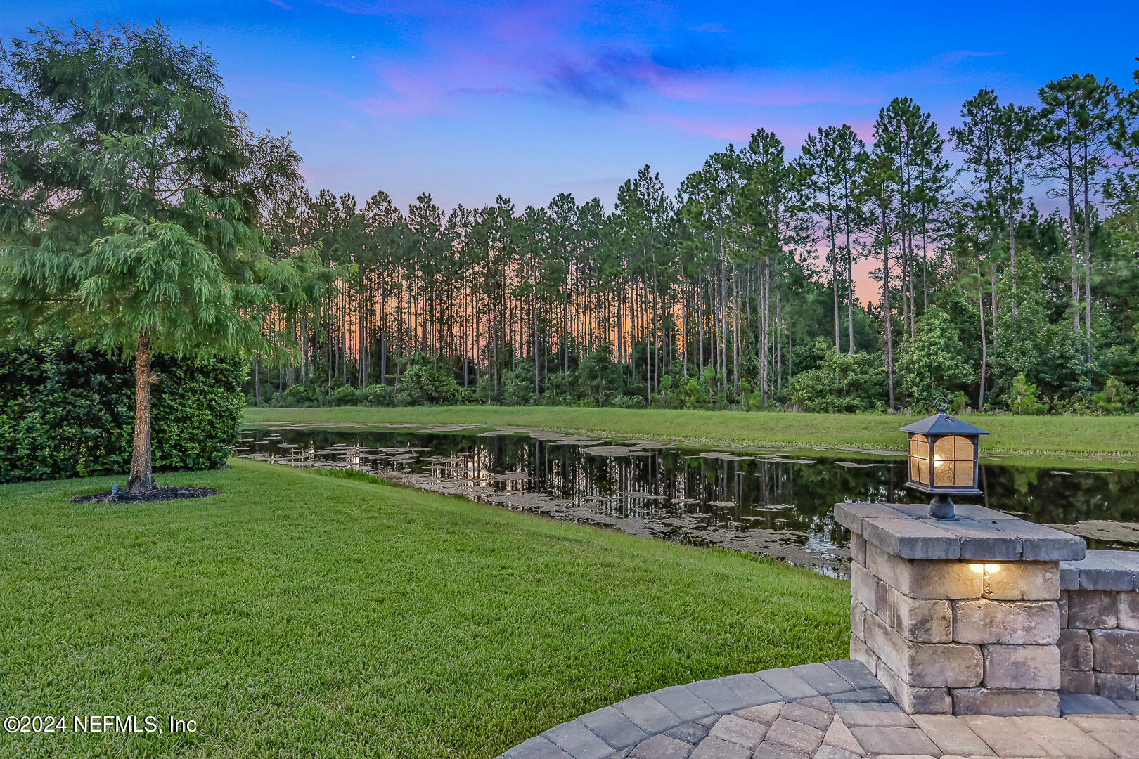 183 Flora Lake Circle St. Augustine, FL 32095 - Photo 4 of 40 a view of a fountain in a yard with a house in the background