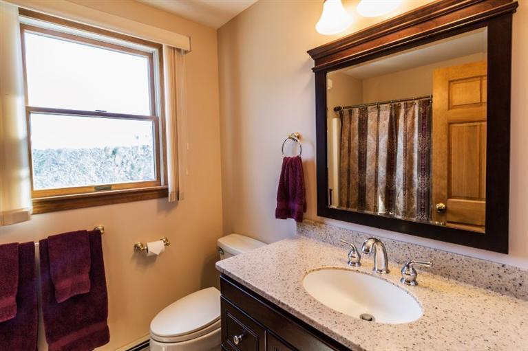 13 Snows Road Truro, MA 02666 - Photo 13 of 28 a bathroom with a granite countertop toilet sink and mirror