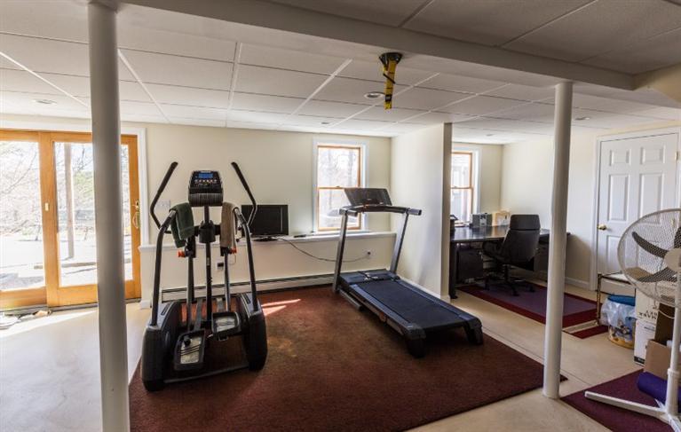 13 Snows Road Truro, MA 02666 - Photo 25 of 28 a living room with furniture gym equipment and a floor to ceiling window