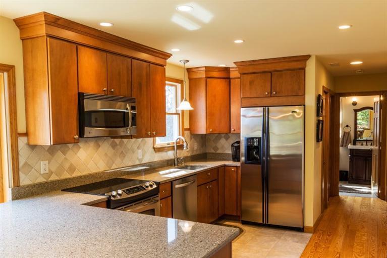 13 Snows Road Truro, MA 02666 - Photo 7 of 28 a kitchen with a sink a counter top space cabinets stainless steel appliances and a window
