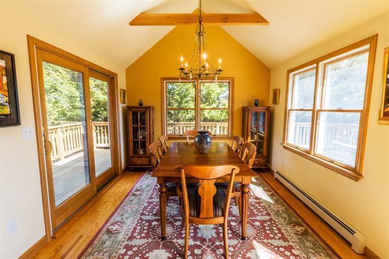 13 Snows Road Truro, MA 02666 - Photo 10 of 28 a dining room with furniture a chandelier and wooden floor