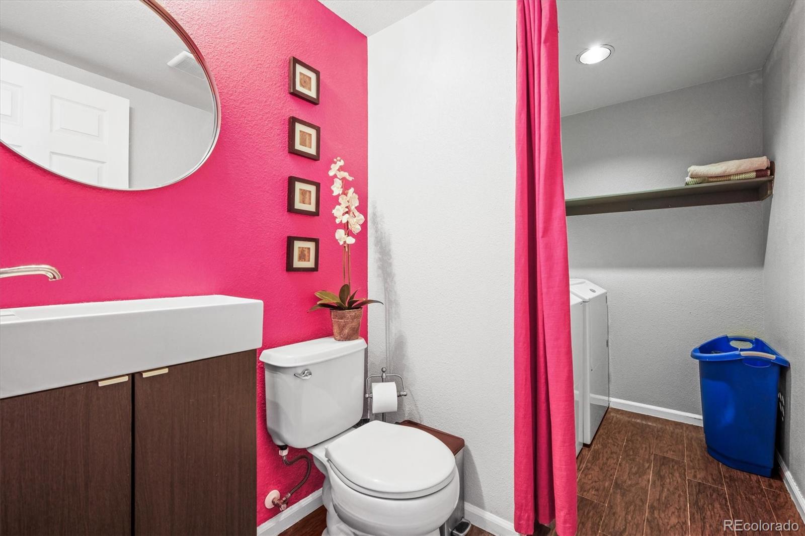 951 Timbervale Trail Highlands Ranch, CO 80129 - Photo 11 of 33 a bathroom with a toilet a sink and mirror