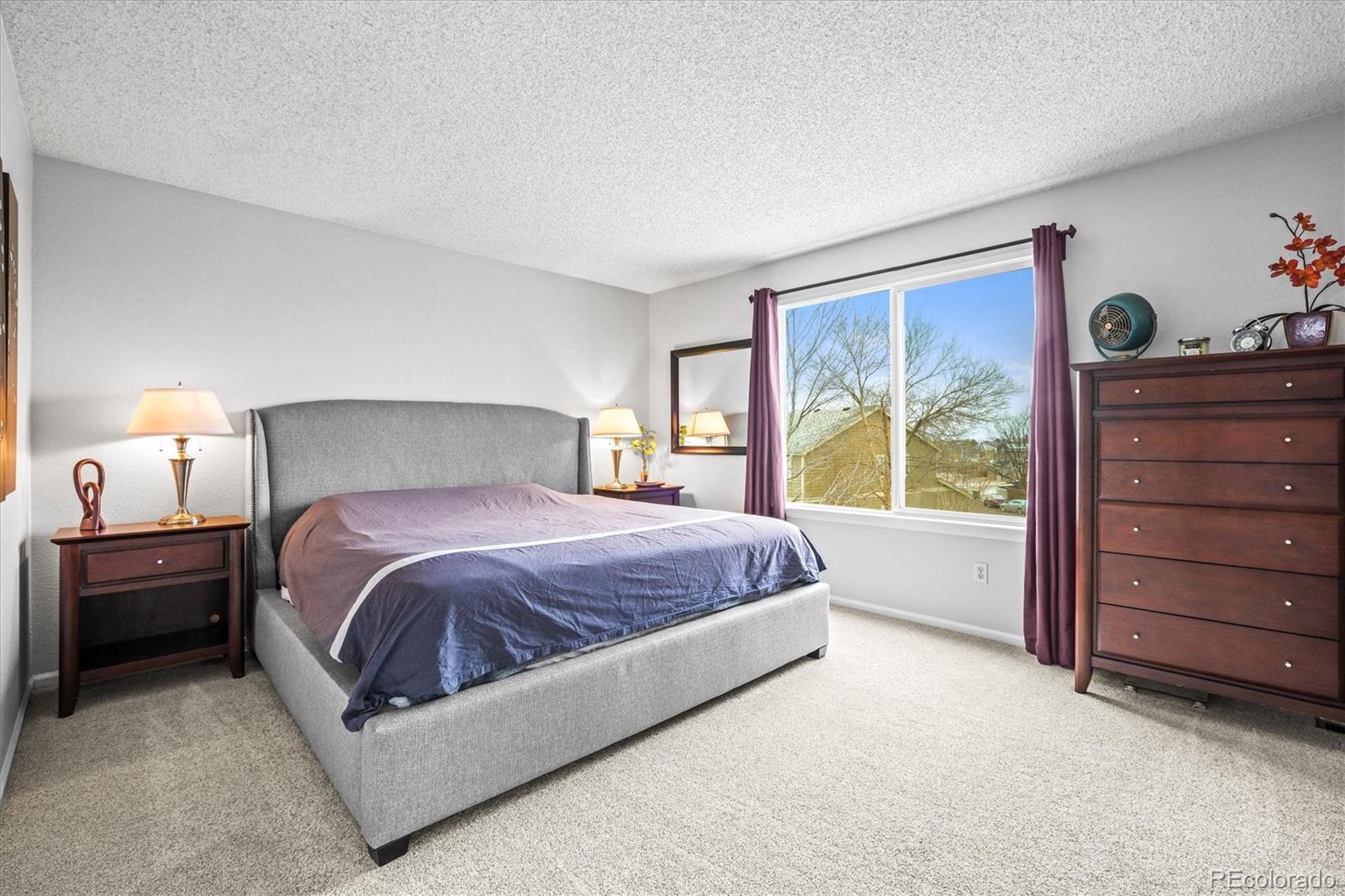 951 Timbervale Trail Highlands Ranch, CO 80129 - Photo 12 of 33 a spacious bedroom with a bed and a window