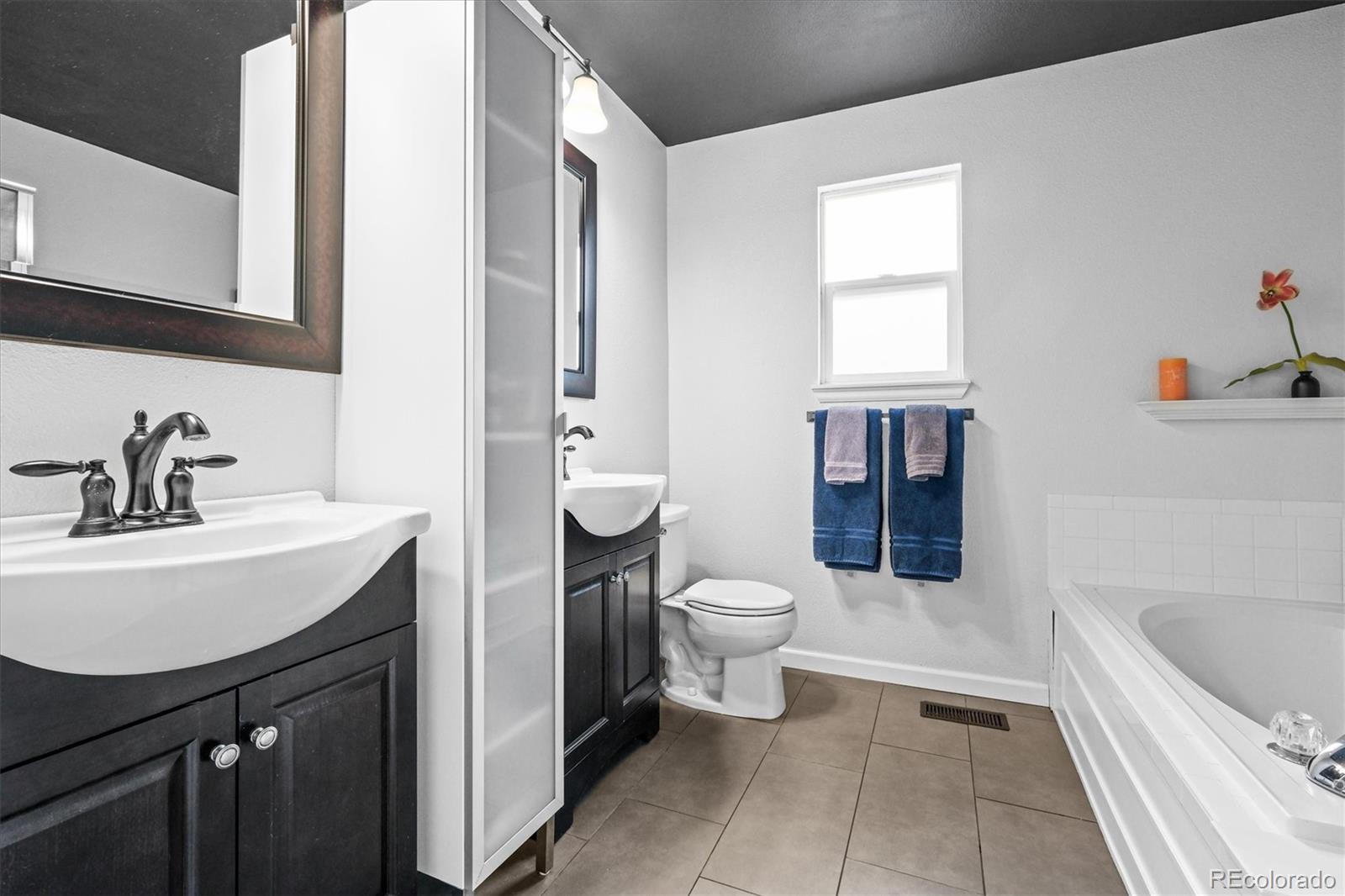 951 Timbervale Trail Highlands Ranch, CO 80129 - Photo 14 of 33 a bathroom with a sink toilet and shower