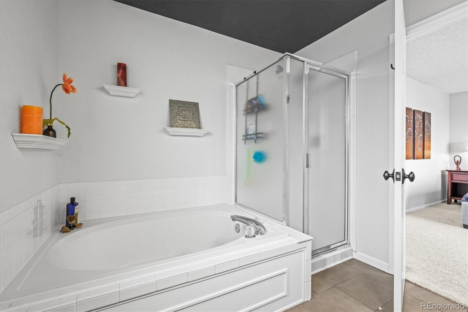 951 Timbervale Trail Highlands Ranch, CO 80129 - Photo 15 of 33 a bathroom with a tub and shower