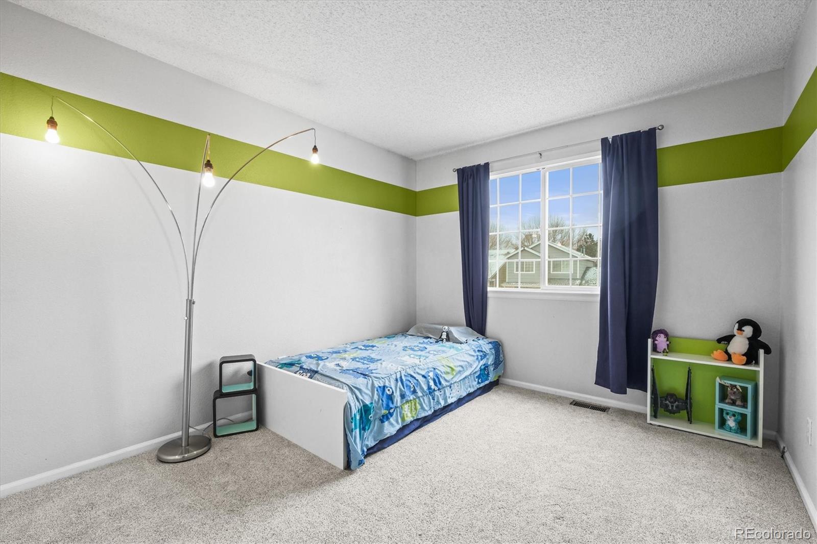 951 Timbervale Trail Highlands Ranch, CO 80129 - Photo 16 of 33 a bedroom with a bed and a window
