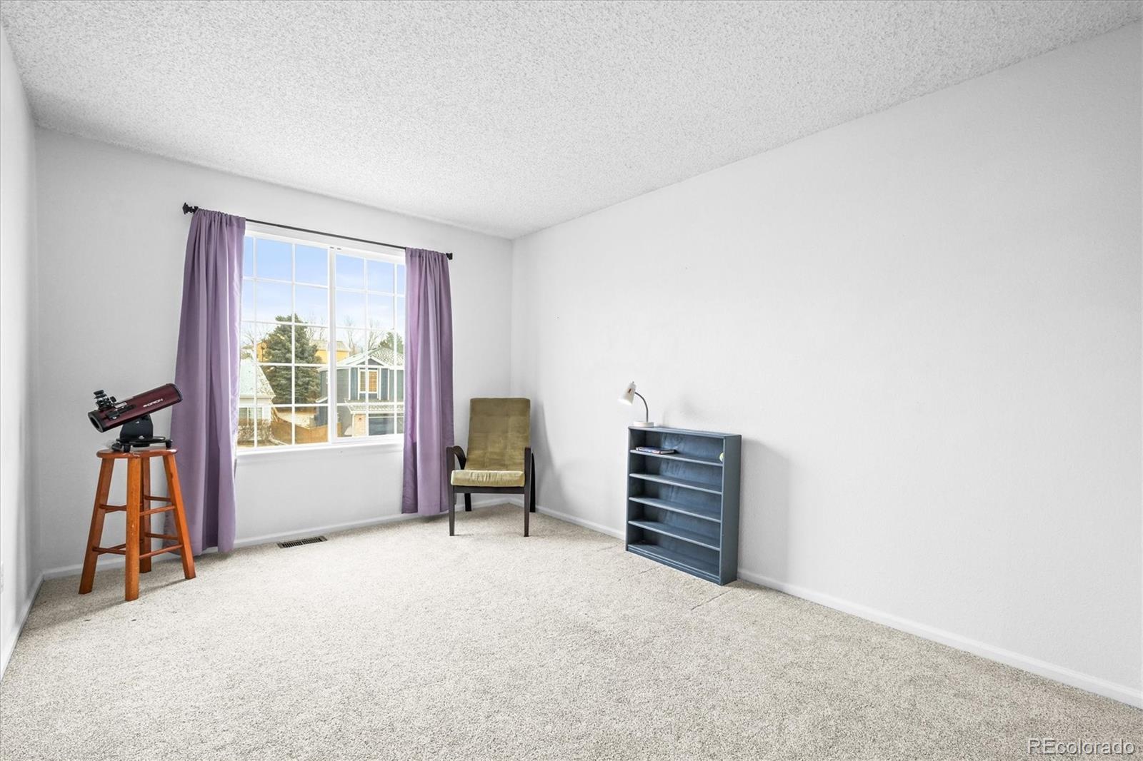 951 Timbervale Trail Highlands Ranch, CO 80129 - Photo 20 of 33 a view of room with window and a ceiling fan