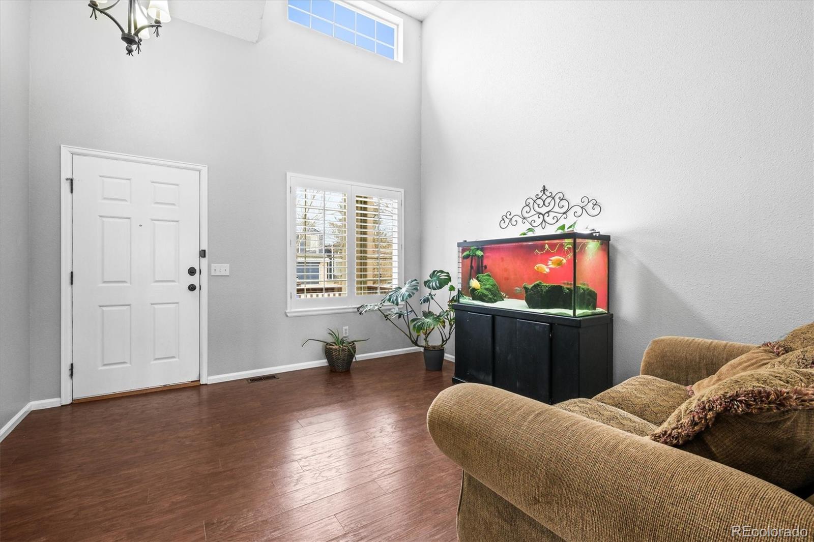 951 Timbervale Trail Highlands Ranch, CO 80129 - Photo 2 of 33 a living room with furniture and a flat screen tv