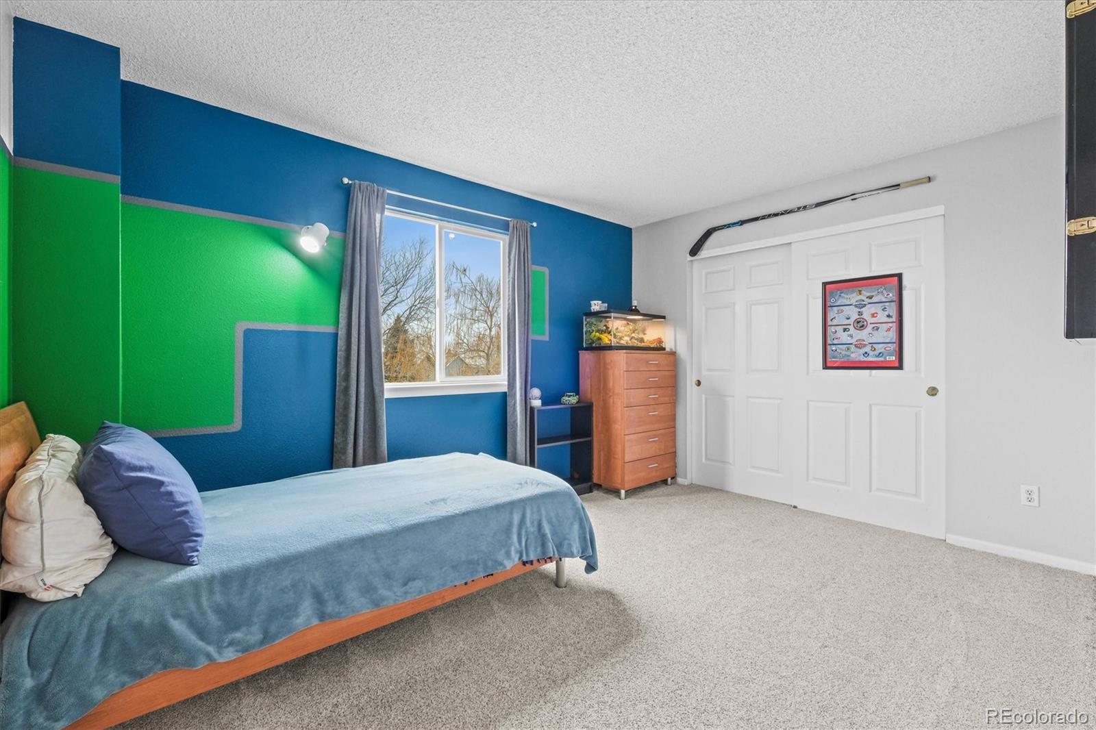 951 Timbervale Trail Highlands Ranch, CO 80129 - Photo 23 of 33 a bedroom with a bed dresser and a large window