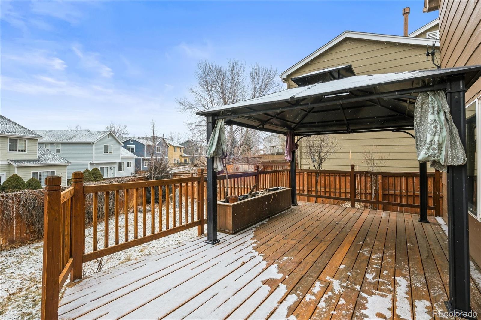 951 Timbervale Trail Highlands Ranch, CO 80129 - Photo 24 of 33 a view of a roof deck with wooden floor and barbeque oven