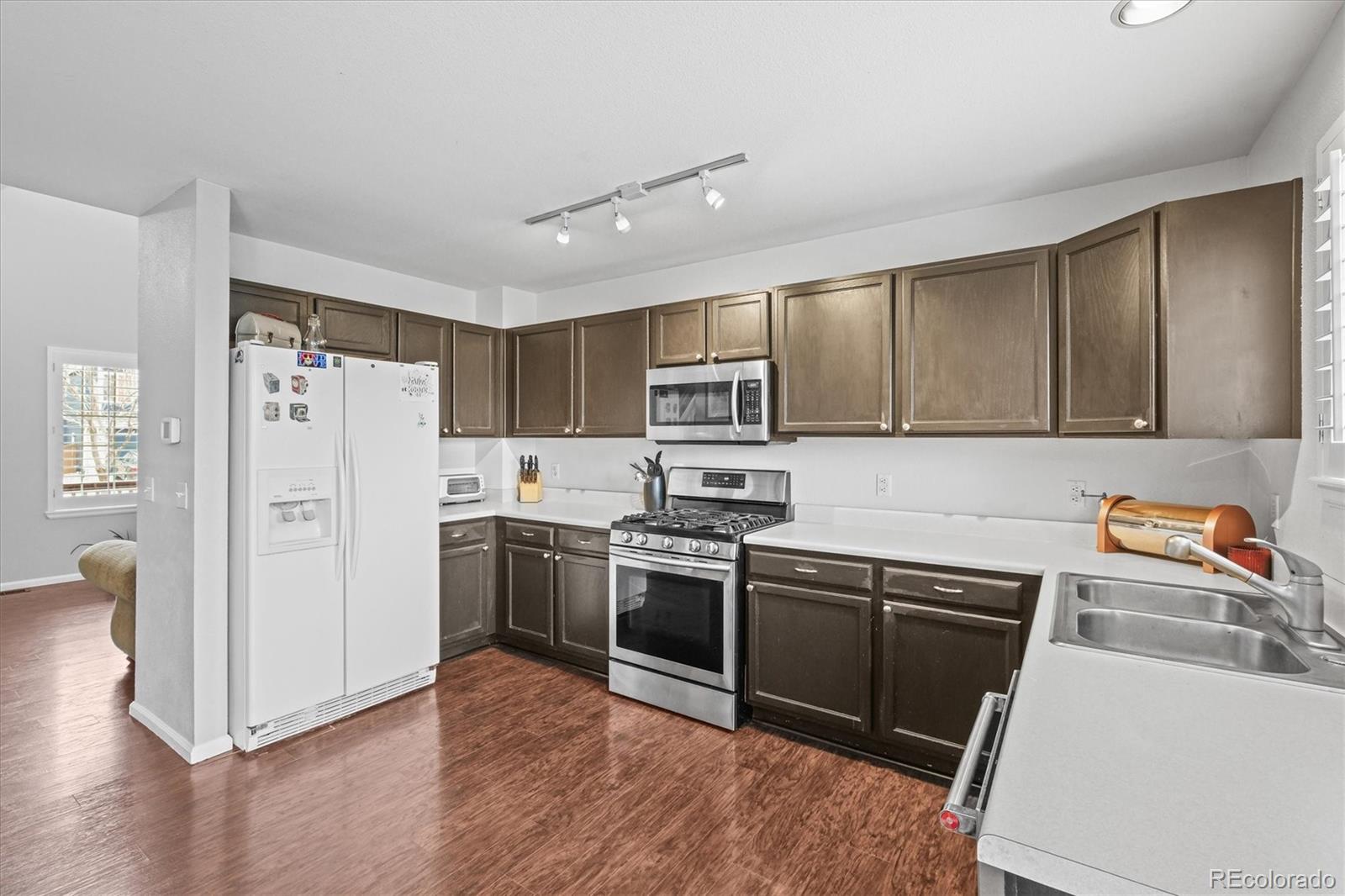 951 Timbervale Trail Highlands Ranch, CO 80129 - Photo 5 of 33 a kitchen with a sink cabinets and stainless steel appliances