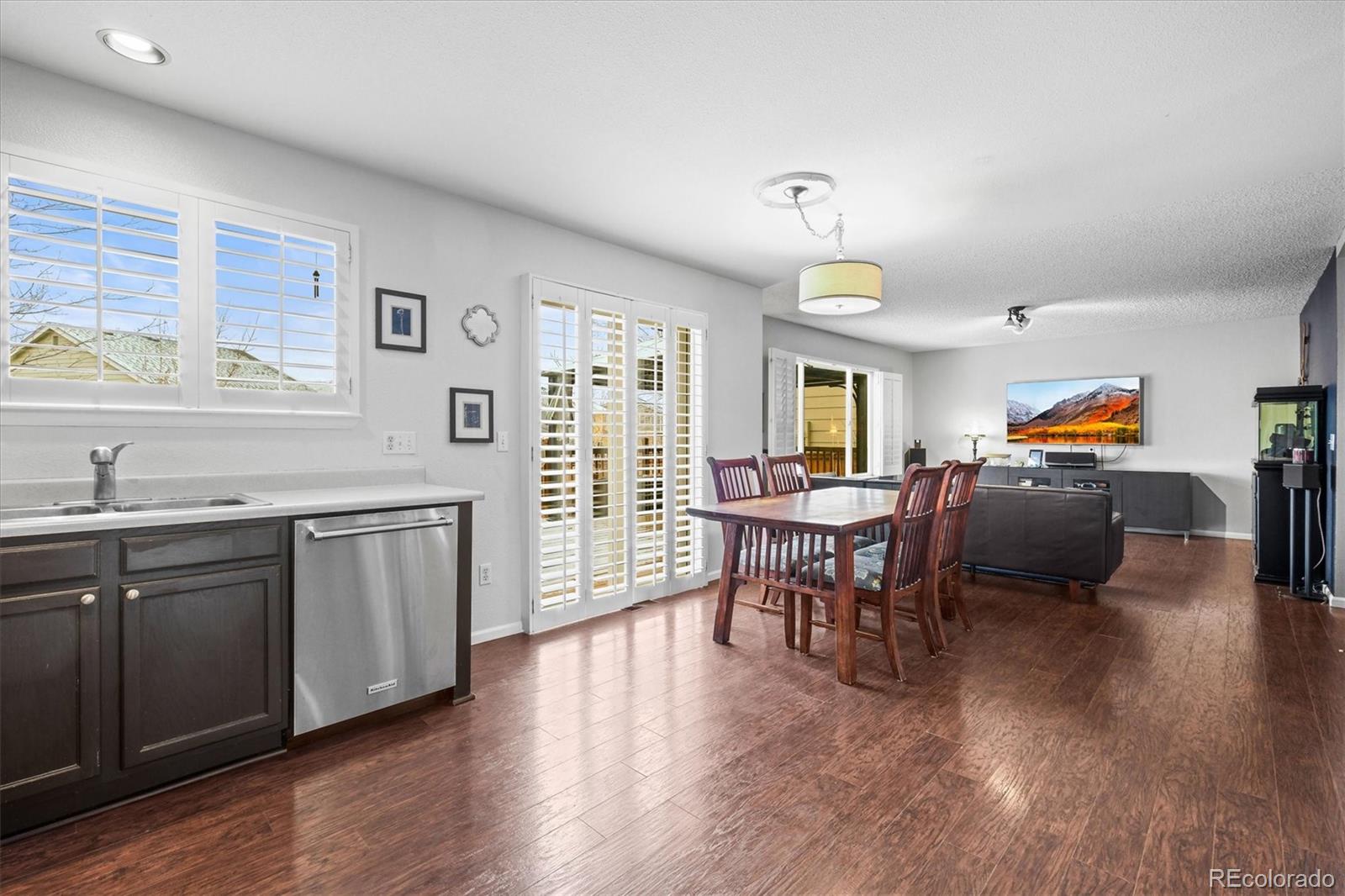 951 Timbervale Trail Highlands Ranch, CO 80129 - Photo 6 of 33 a living room with furniture a dining table and a window