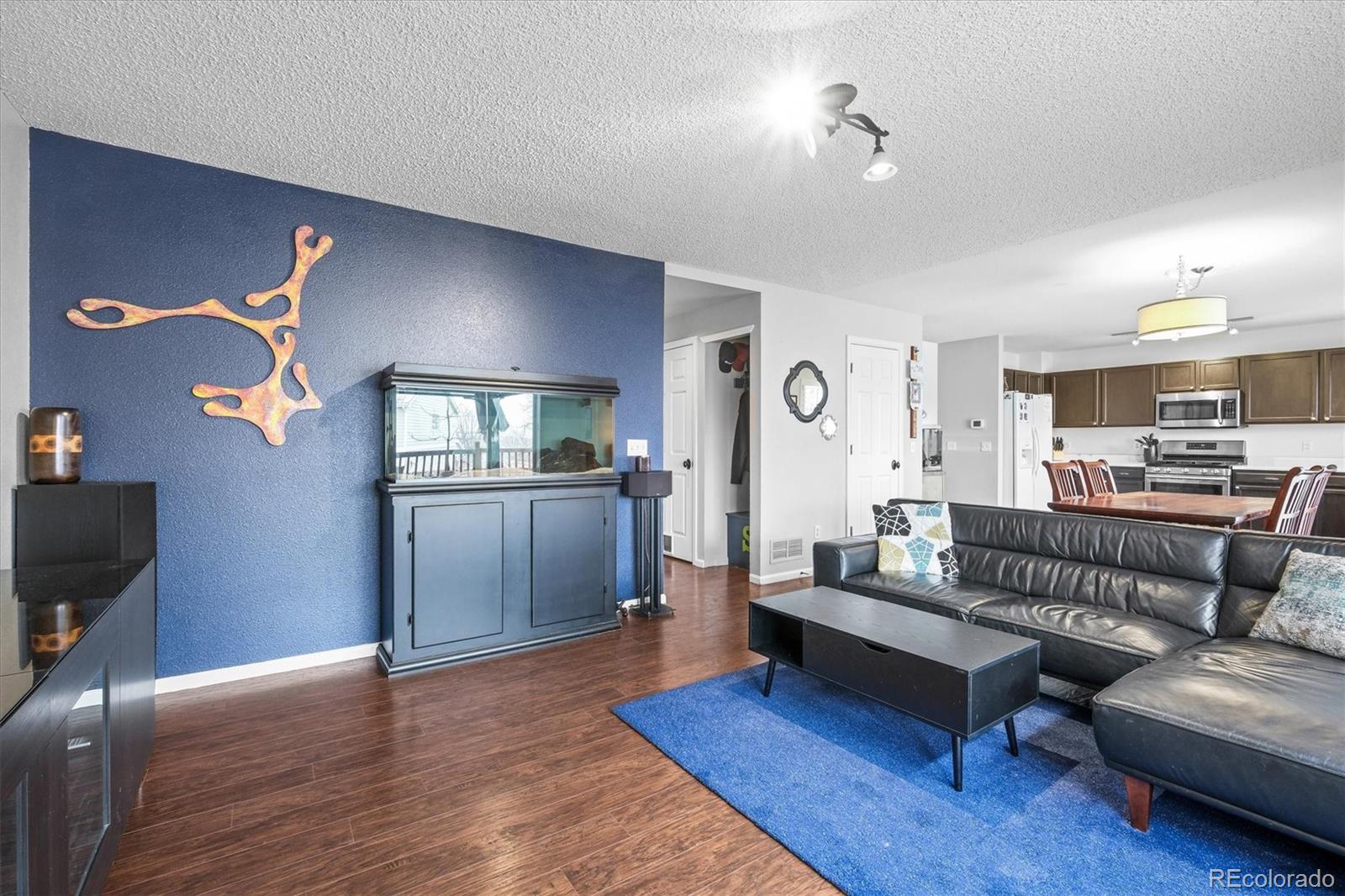 951 Timbervale Trail Highlands Ranch, CO 80129 - Photo 10 of 33 a living room with furniture and a wooden floor