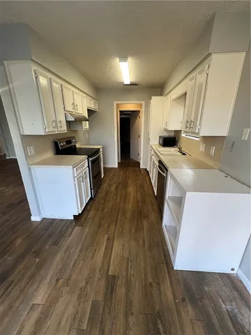 a kitchen with sink a stove and refrigerator