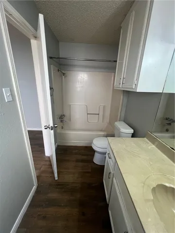 a bathroom with a sink a toilet and a shower