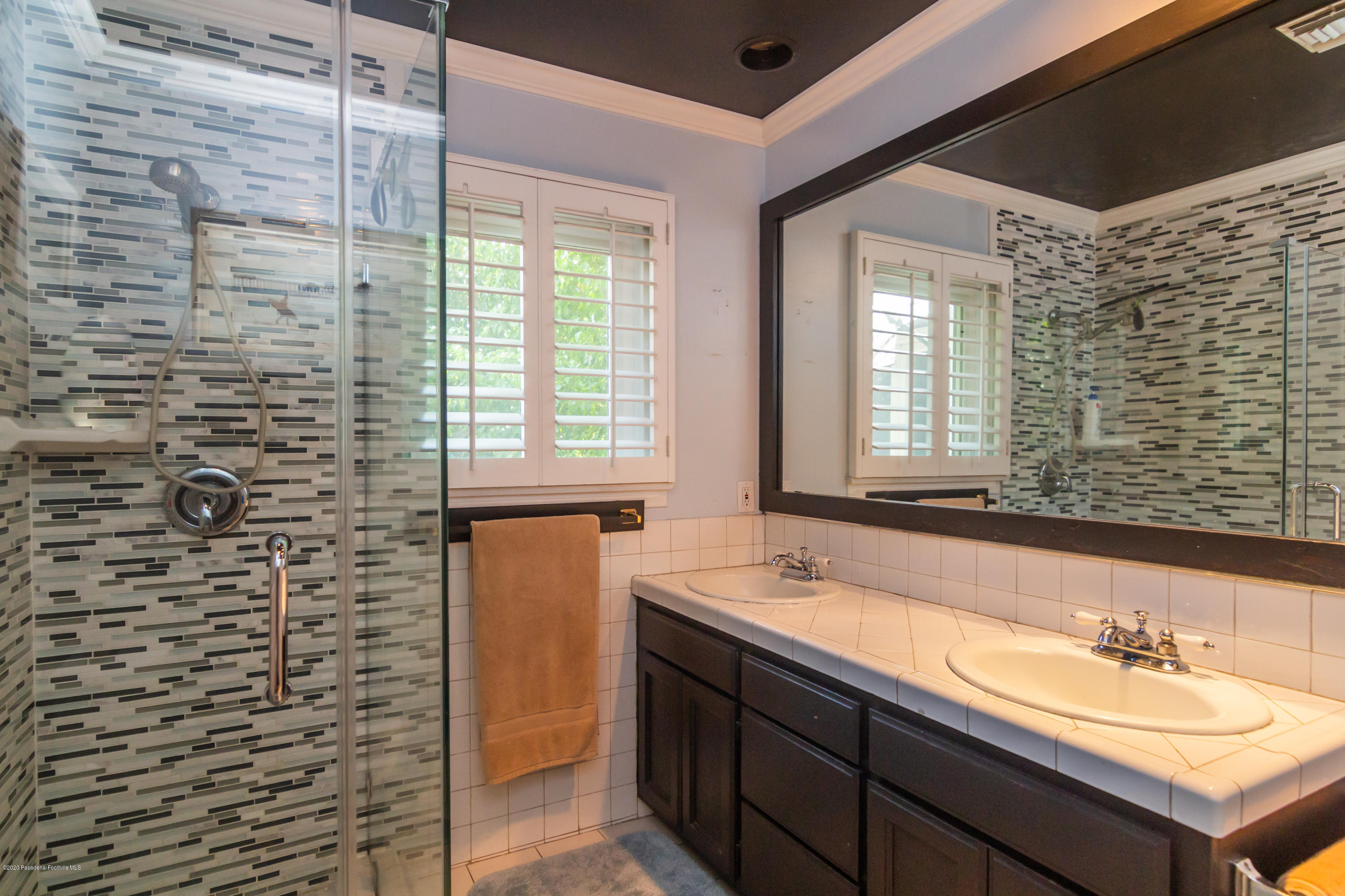 266 Melcanyon Road Duarte, CA 91010 - Photo 14 of 27 a bathroom with a granite countertop sink a mirror and a shower