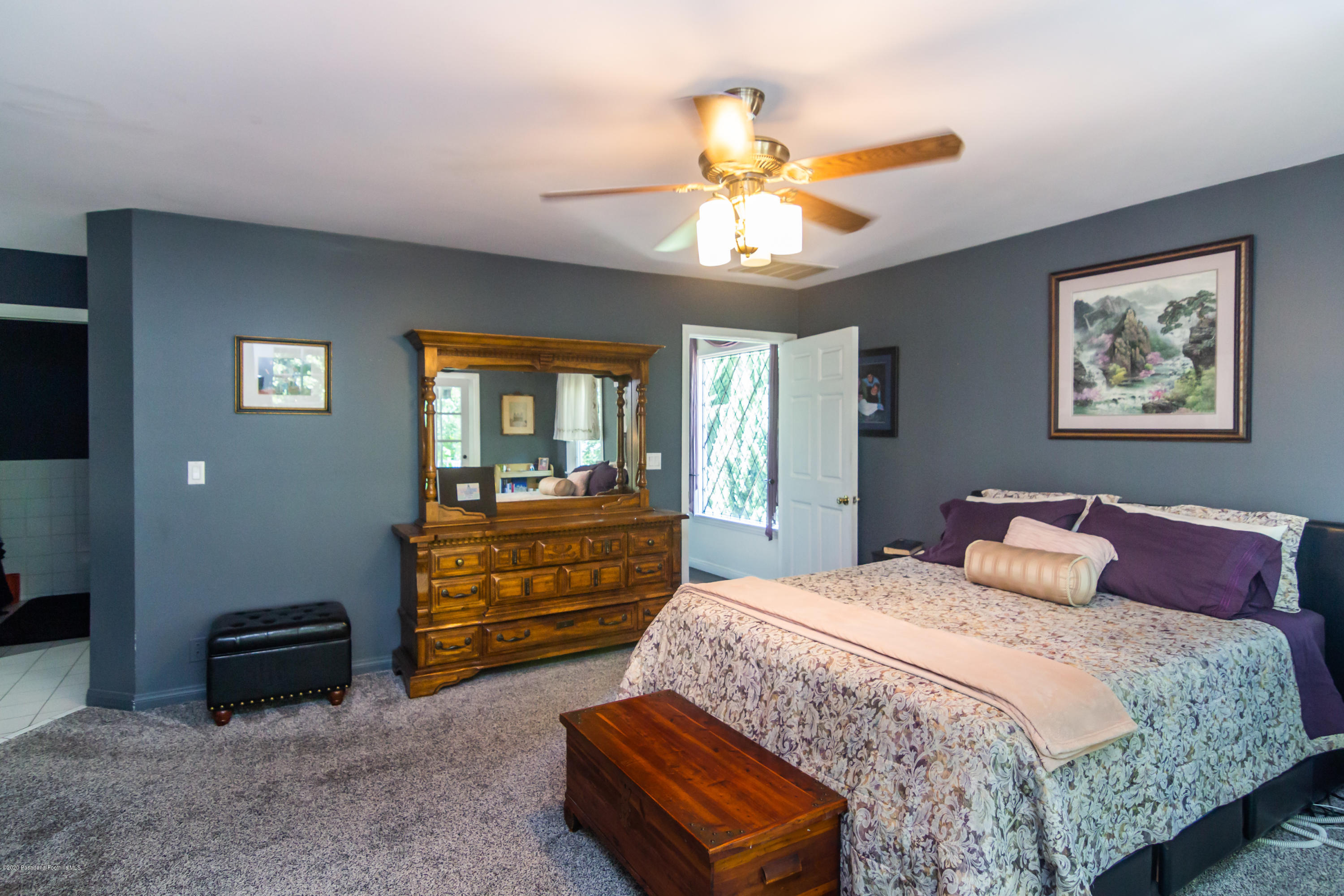 266 Melcanyon Road Duarte, CA 91010 - Photo 16 of 27 a bedroom with a bed and a chandelier