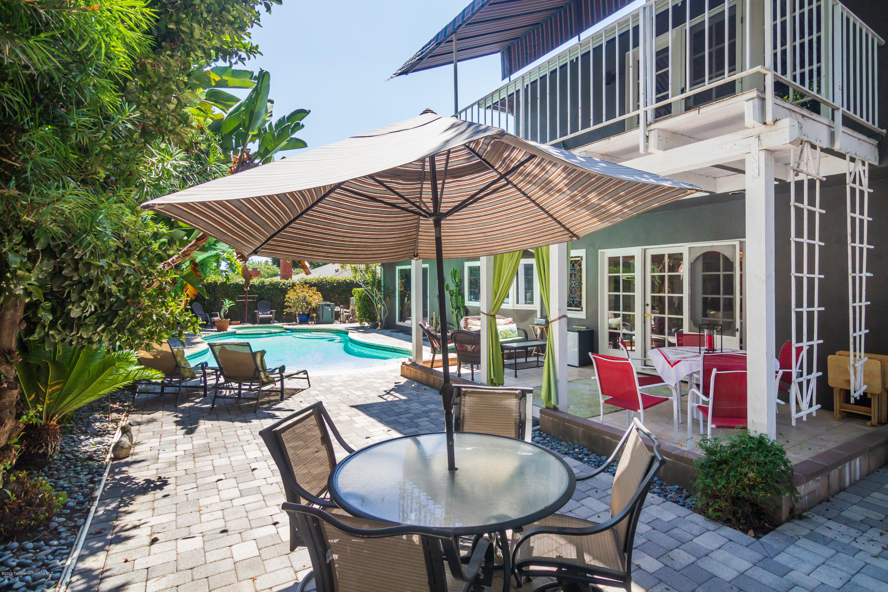 266 Melcanyon Road Duarte, CA 91010 - Photo 21 of 27 a view of a patio with table and chairs under an umbrella