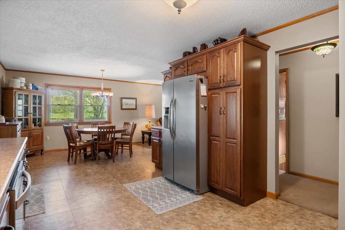48 Hill Road Big Sandy, TN 38221 - Photo 13 of 54 a dining room with stainless steel appliances granite countertop furniture and a window