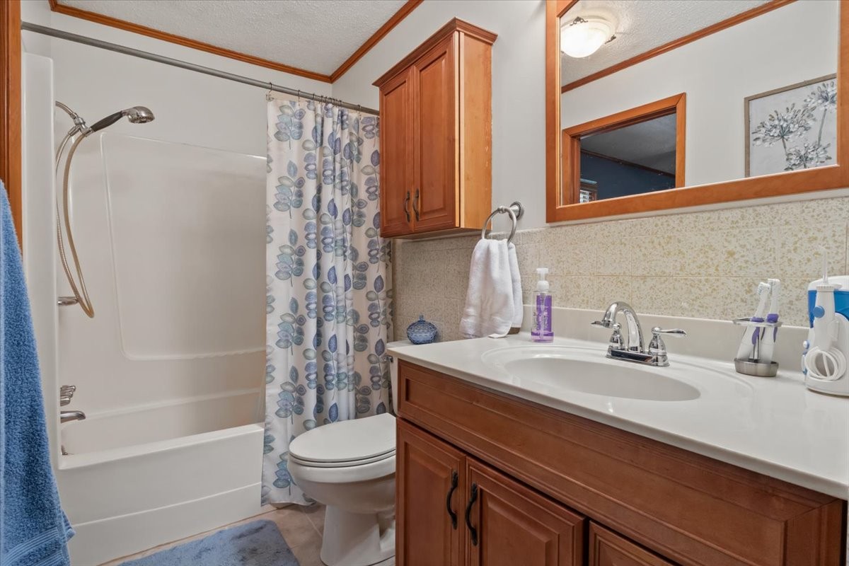 48 Hill Road Big Sandy, TN 38221 - Photo 16 of 54 a bathroom with a sink a toilet and shower