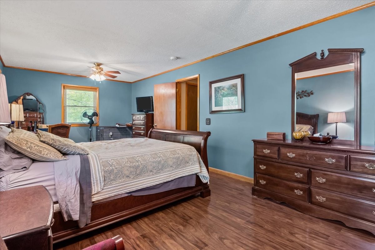 48 Hill Road Big Sandy, TN 38221 - Photo 18 of 54 a bedroom with a bed and a dresser