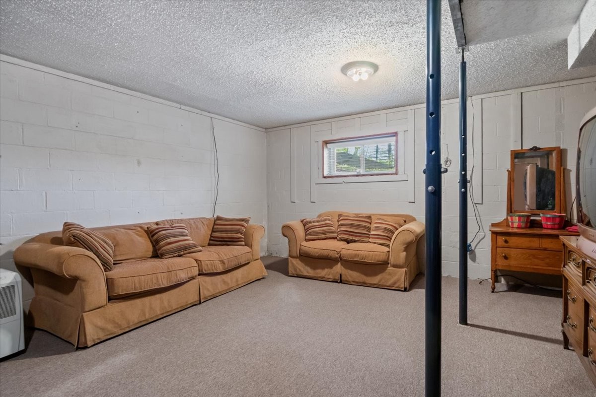 48 Hill Road Big Sandy, TN 38221 - Photo 20 of 54 a living room with furniture and a flat screen tv
