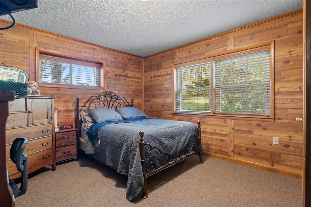 48 Hill Road Big Sandy, TN 38221 - Photo 22 of 54 a bedroom with a bed and a large window