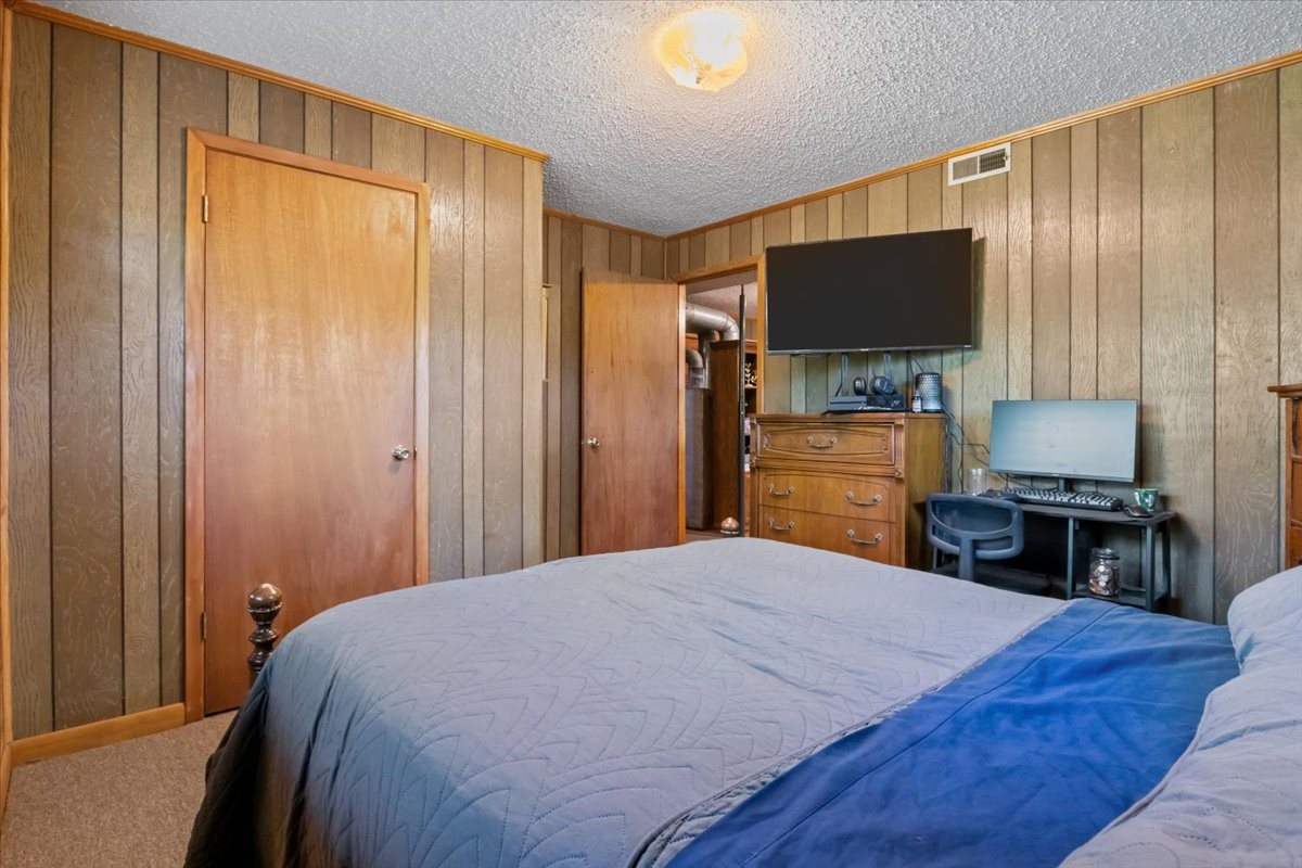 48 Hill Road Big Sandy, TN 38221 - Photo 23 of 54 a bedroom with a bed and a flat screen tv