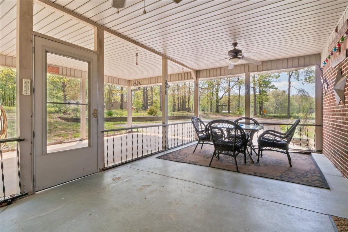 48 Hill Road Big Sandy, TN 38221 - Photo 28 of 54 a dining room with furniture a chandelier and hardwood