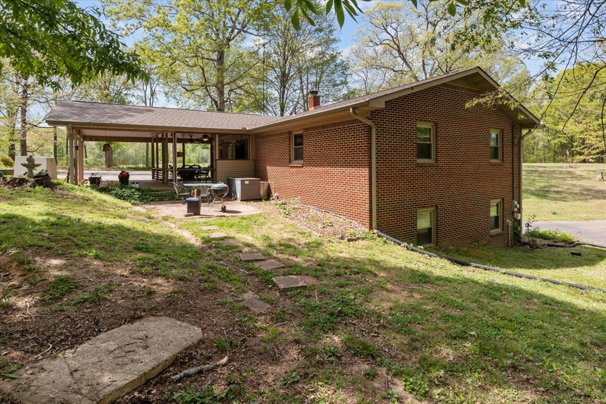 48 Hill Road Big Sandy, TN 38221 - Photo 30 of 54 a view of a house with backyard porch and sitting area