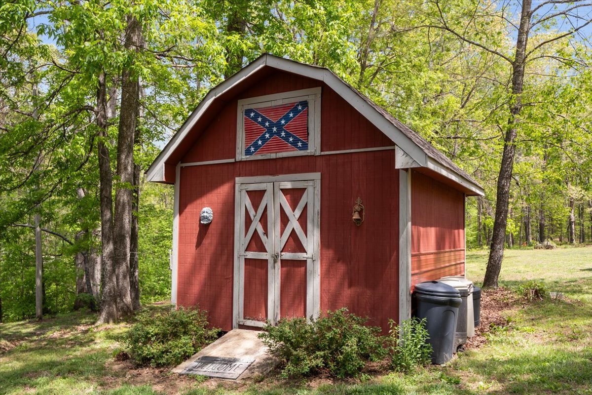 48 Hill Road Big Sandy, TN 38221 - Photo 32 of 54 a view of a small house with a tree in the yard