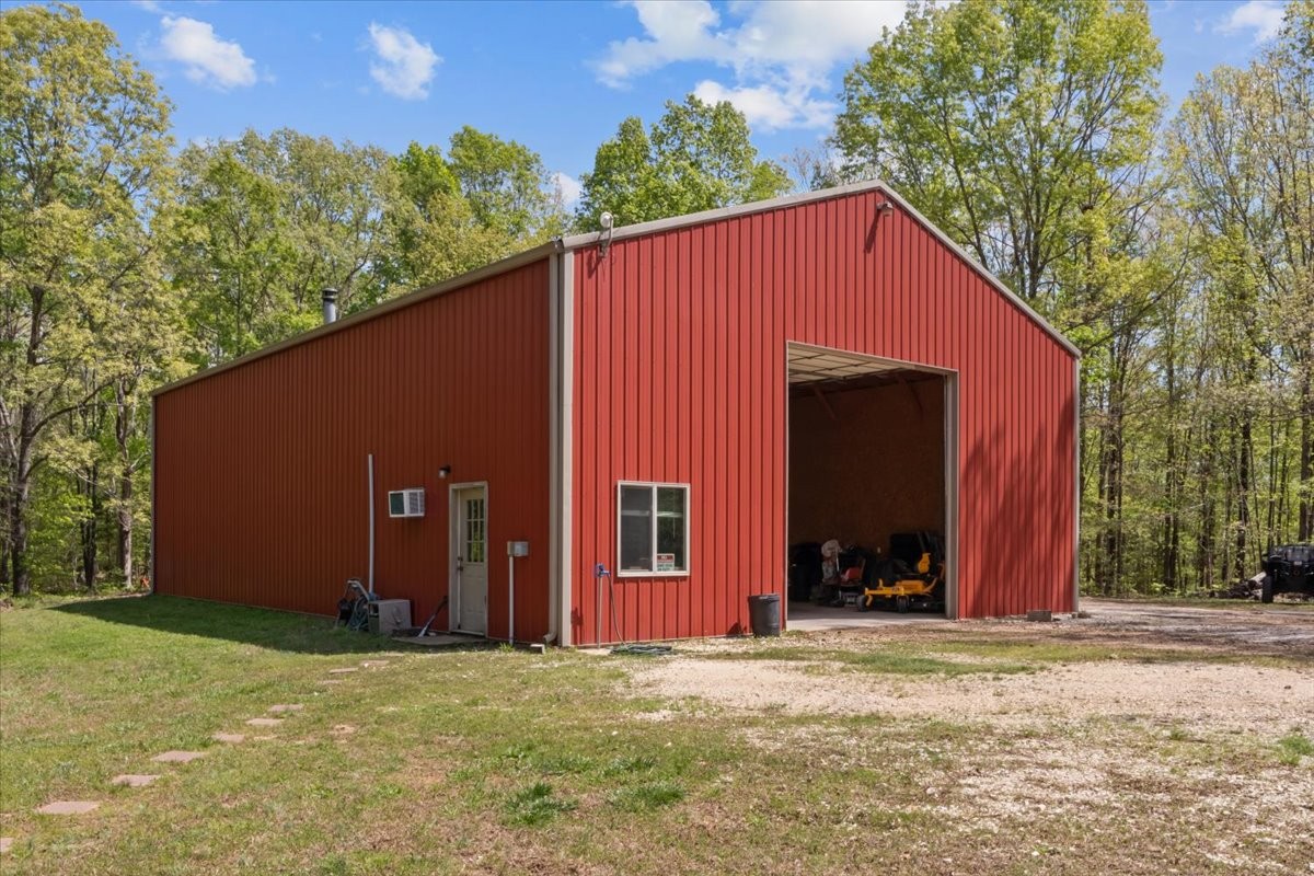 48 Hill Road Big Sandy, TN 38221 - Photo 34 of 54 a view of a house with backyard and trees