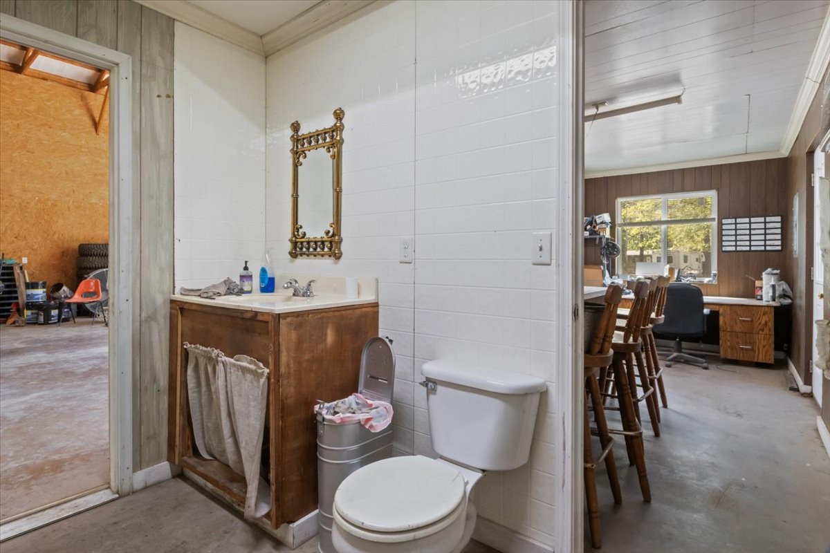 48 Hill Road Big Sandy, TN 38221 - Photo 35 of 54 a bathroom with a toilet a sink and a mirror
