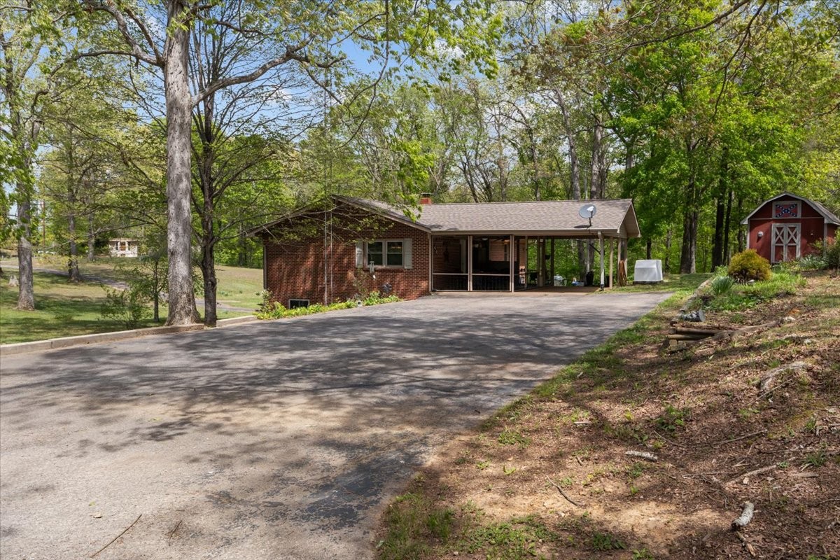 48 Hill Road Big Sandy, TN 38221 - Photo 40 of 54 a front view of a house with a yard