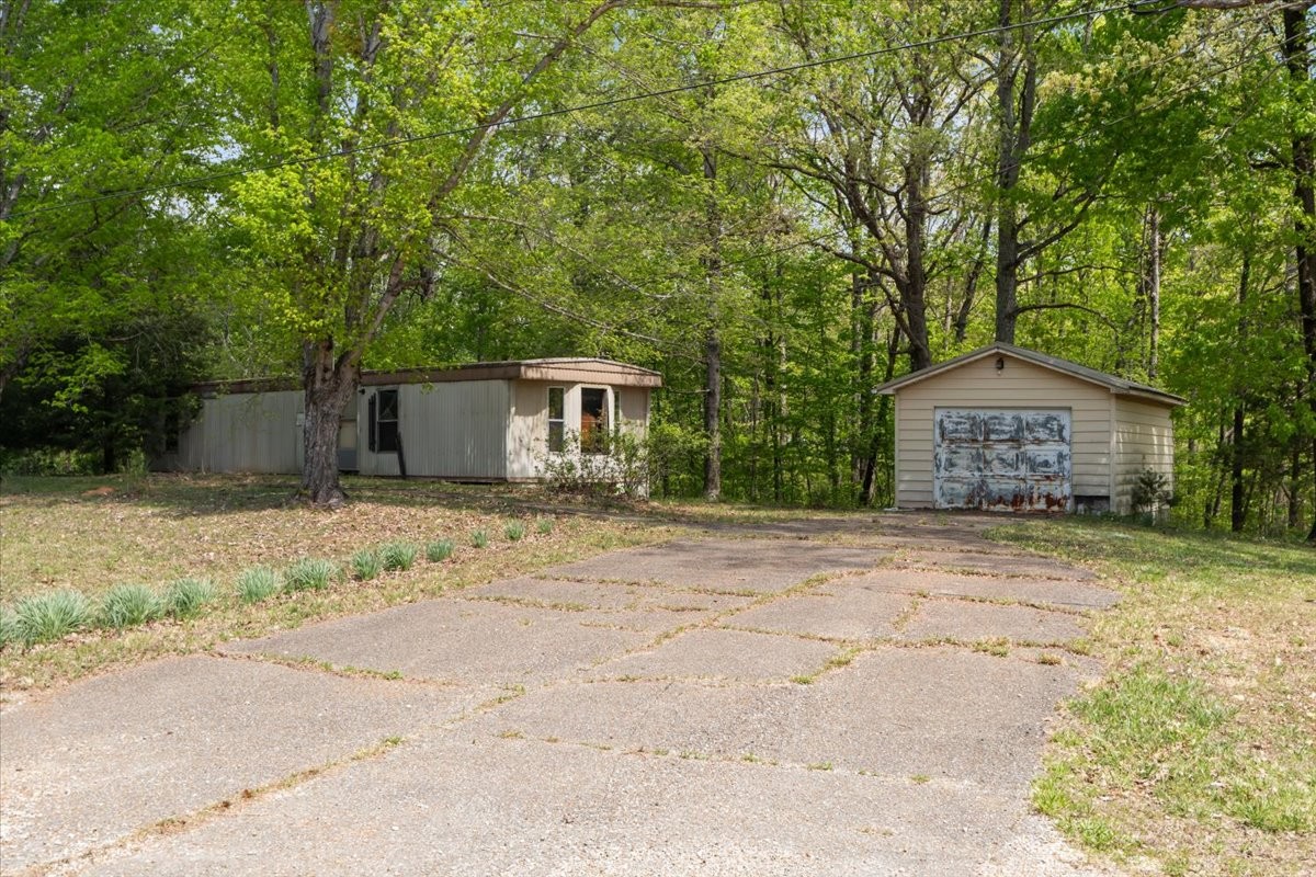 48 Hill Road Big Sandy, TN 38221 - Photo 42 of 54 a house with trees in front of it