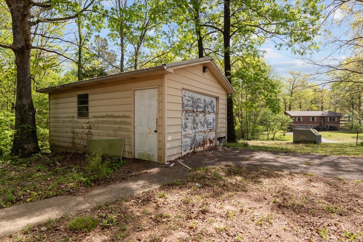 48 Hill Road Big Sandy, TN 38221 - Photo 43 of 54 a view of a house with a yard