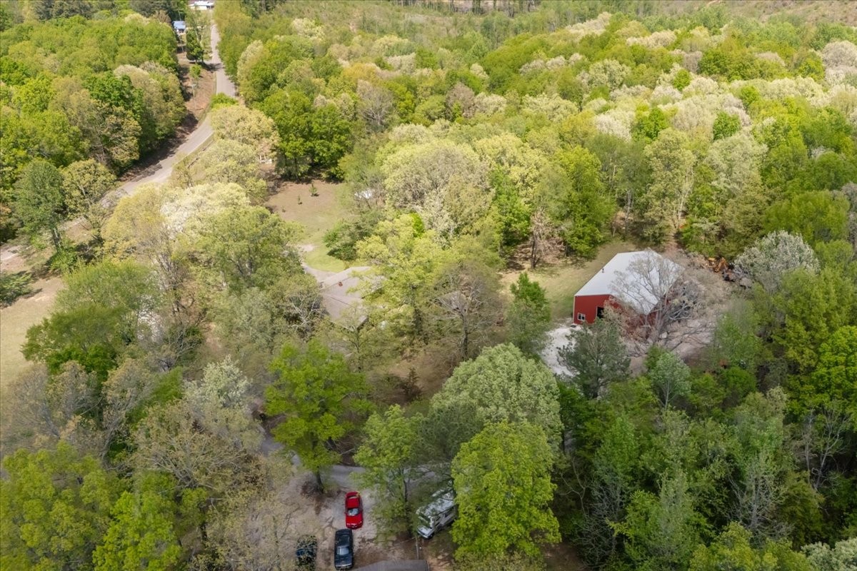 48 Hill Road Big Sandy, TN 38221 - Photo 53 of 54 a backyard of a house with lots of green space and garden