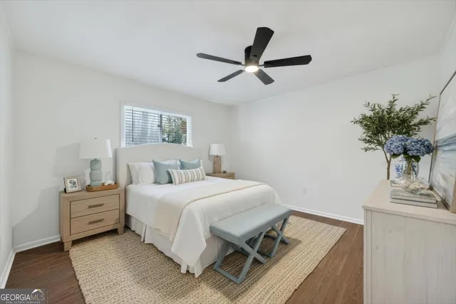 a bedroom with a bed and a potted plant