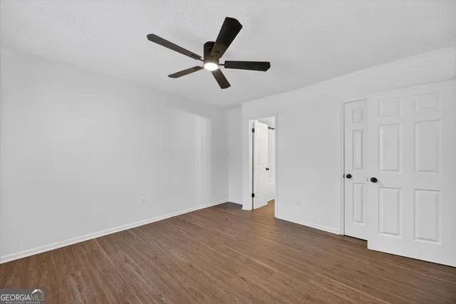 a view of an empty room and wooden floor