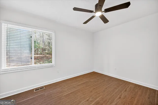 wooden floor in an empty room with a window